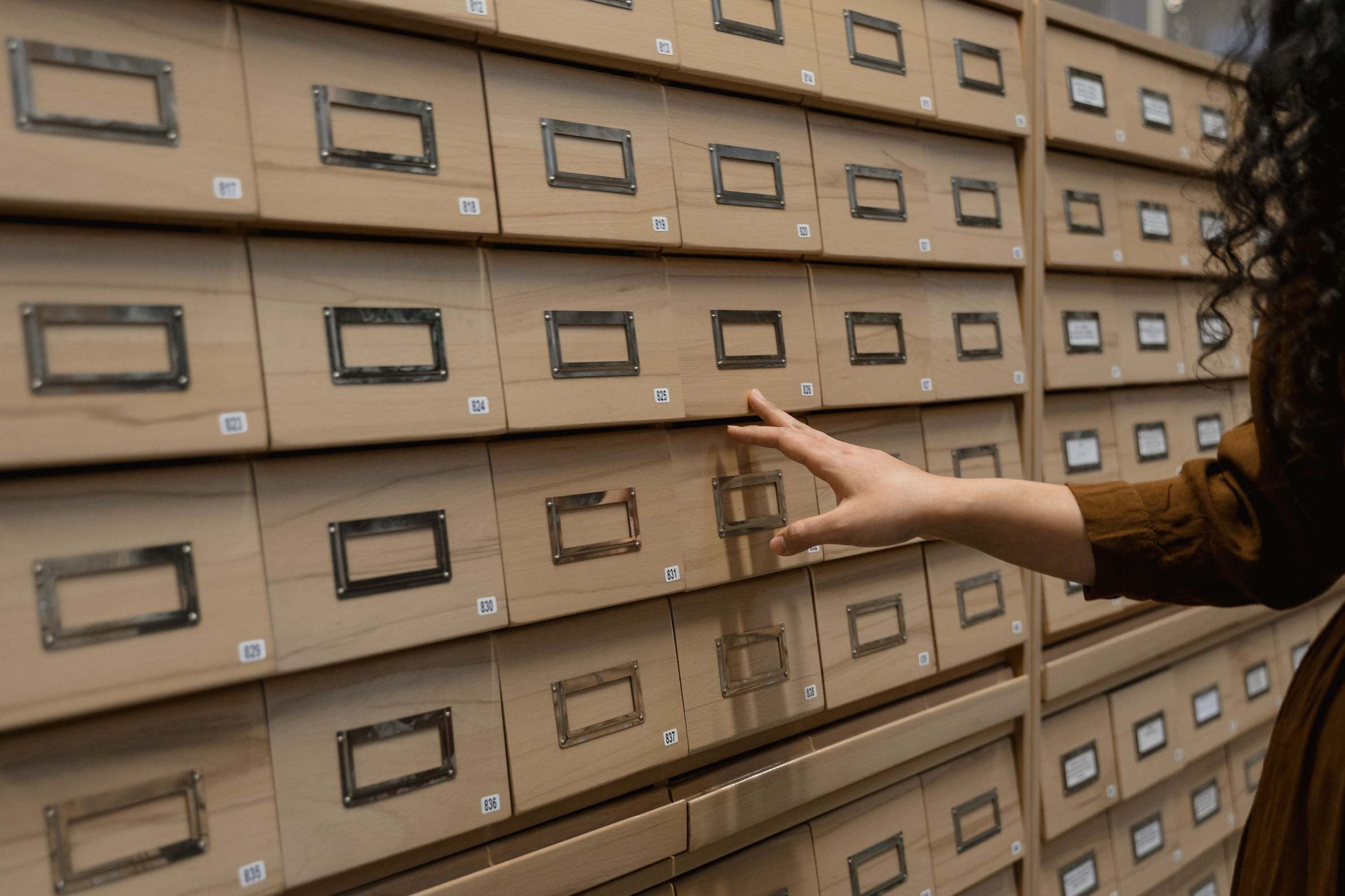 Archive storage drawers with records being organized